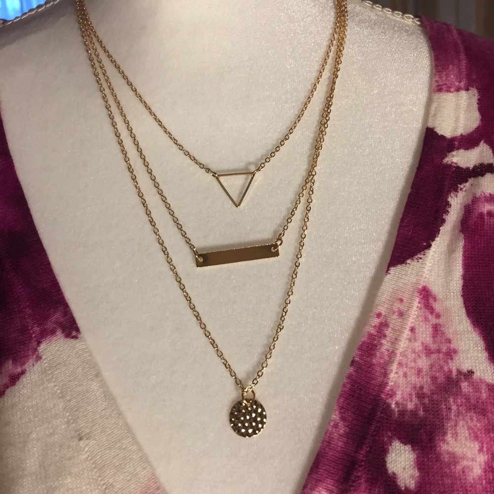 Triple strand gold tone necklace
